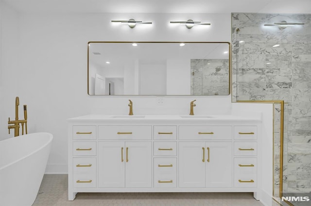 bathroom with tile patterned flooring, vanity, and separate shower and tub