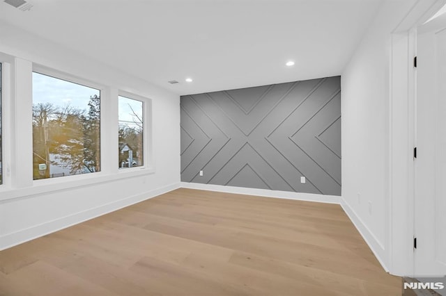 unfurnished room with light wood-type flooring