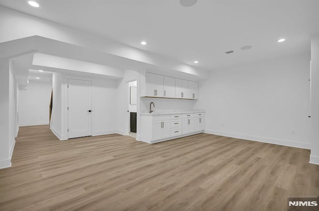 interior space with light hardwood / wood-style flooring and sink