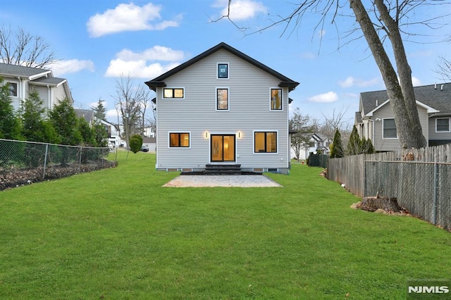 rear view of property featuring a yard and a patio