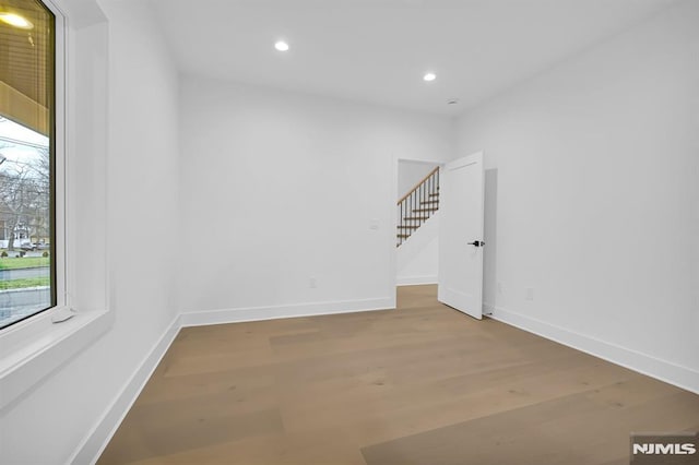 unfurnished room with hardwood / wood-style floors