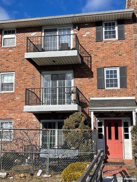 view of front of house featuring a balcony