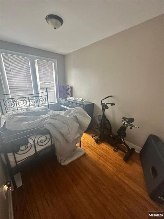 bedroom with wood-type flooring