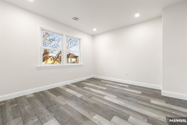 unfurnished room featuring hardwood / wood-style flooring