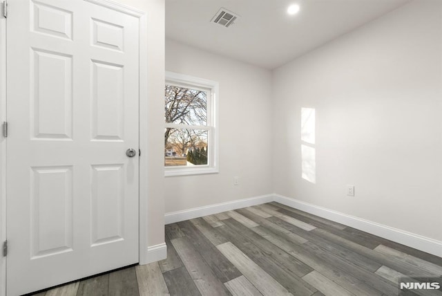 empty room with hardwood / wood-style floors