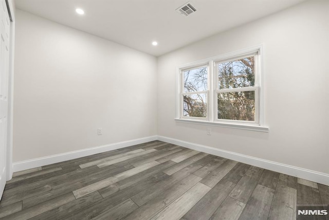 empty room featuring dark hardwood / wood-style flooring