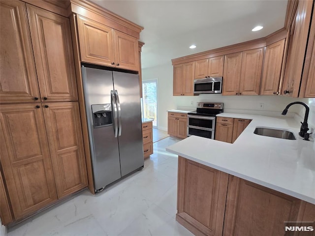 kitchen featuring kitchen peninsula, sink, and appliances with stainless steel finishes