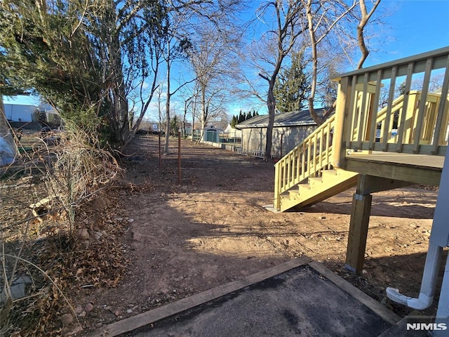 view of yard featuring a wooden deck