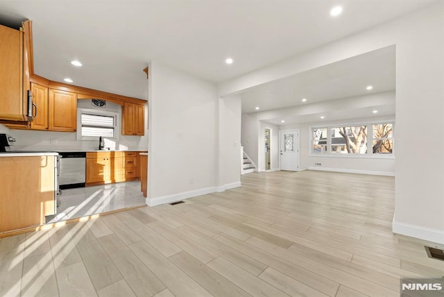 kitchen featuring sink, light wood-type flooring, and appliances with stainless steel finishes