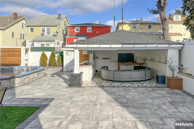 rear view of house featuring outdoor lounge area and a patio area