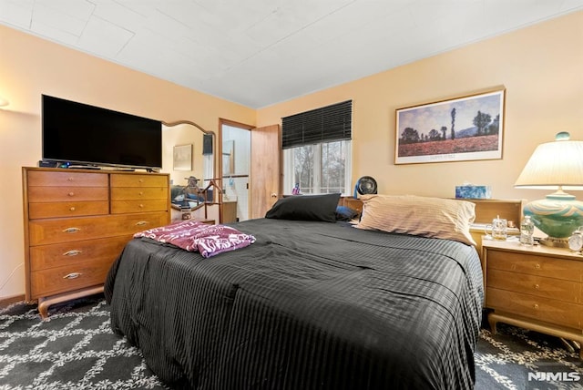 bedroom featuring dark colored carpet