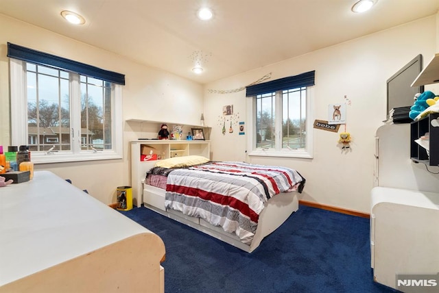 carpeted bedroom with multiple windows