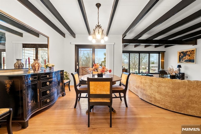 dining area featuring beam ceiling, light hardwood / wood-style flooring, and a chandelier