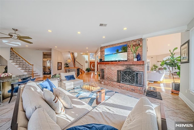 living room featuring ceiling fan and a fireplace