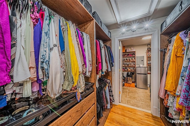 spacious closet with light hardwood / wood-style floors