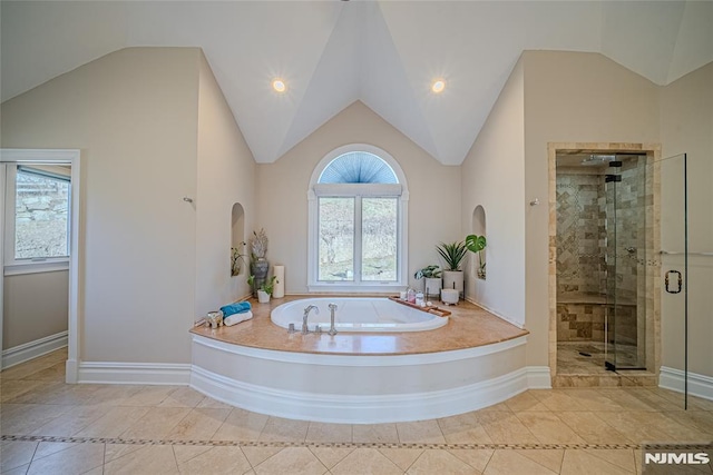 bathroom featuring tile patterned flooring, lofted ceiling, and shower with separate bathtub