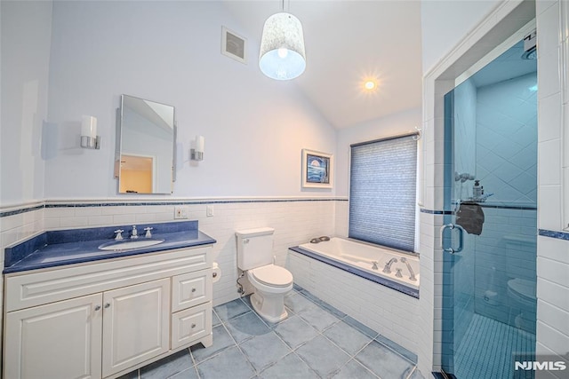 full bathroom with vanity, vaulted ceiling, plus walk in shower, tile patterned flooring, and toilet