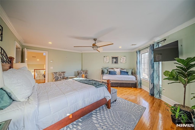 bedroom featuring ceiling fan, light wood-type flooring, and ornamental molding