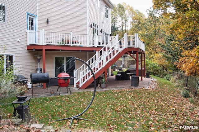 rear view of house with a patio area, a yard, and a deck