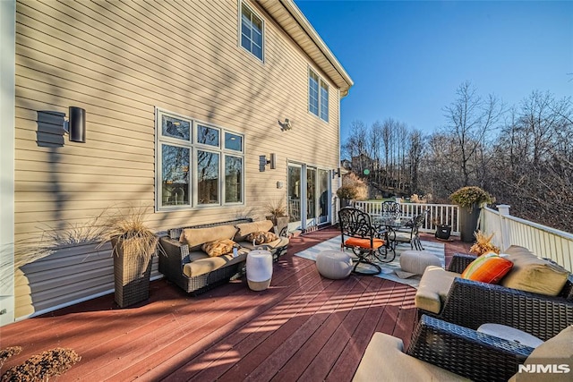 wooden terrace with outdoor lounge area