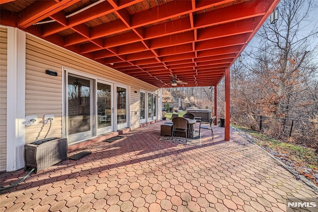 view of patio featuring ceiling fan and a hot tub