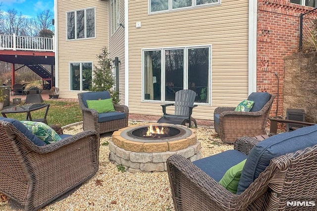 view of patio featuring a wooden deck and an outdoor fire pit