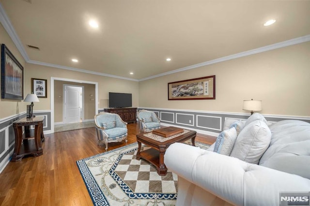 living room featuring wood-type flooring and ornamental molding