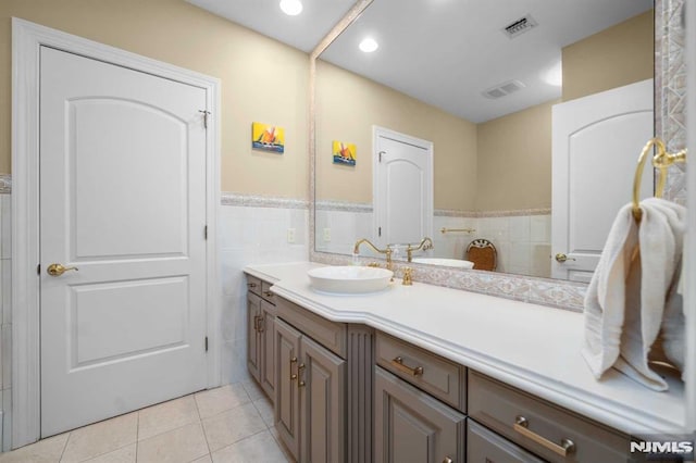 bathroom with tile patterned floors, vanity, and tile walls