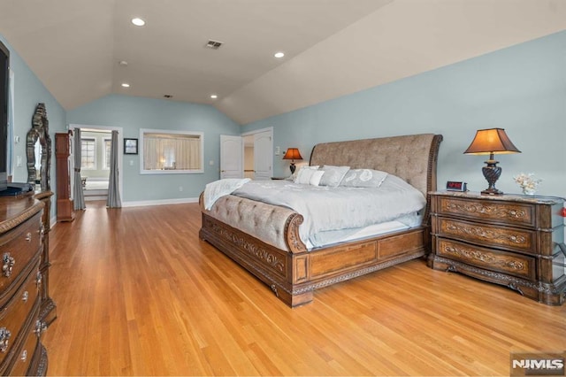 bedroom with light hardwood / wood-style flooring and lofted ceiling