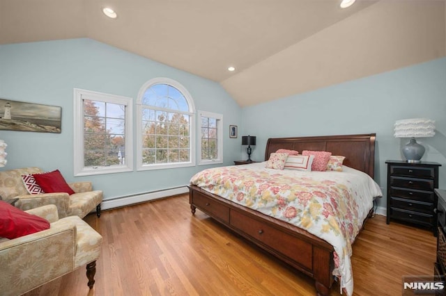 bedroom with light hardwood / wood-style floors, lofted ceiling, and baseboard heating