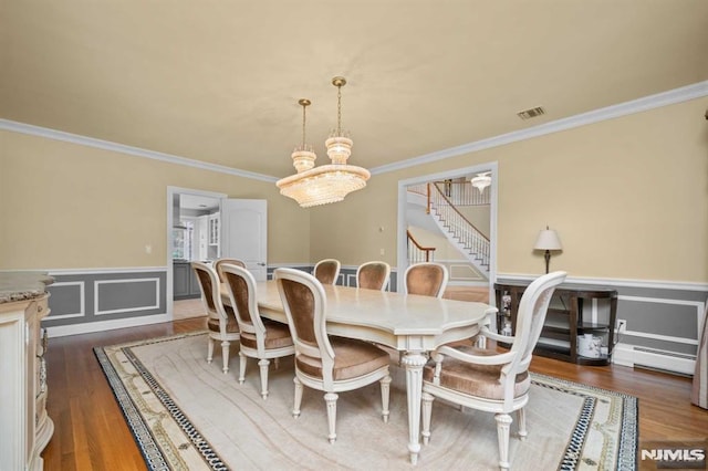 dining room with a baseboard radiator, a chandelier, dark hardwood / wood-style floors, and ornamental molding