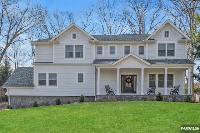 view of front of home with covered porch and a front yard