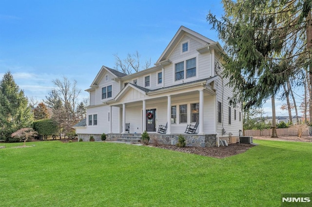 craftsman house featuring central AC unit, covered porch, and a front lawn