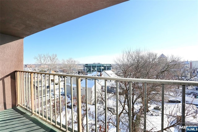 view of snow covered back of property