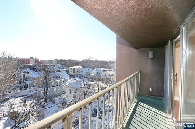 view of snow covered back of property