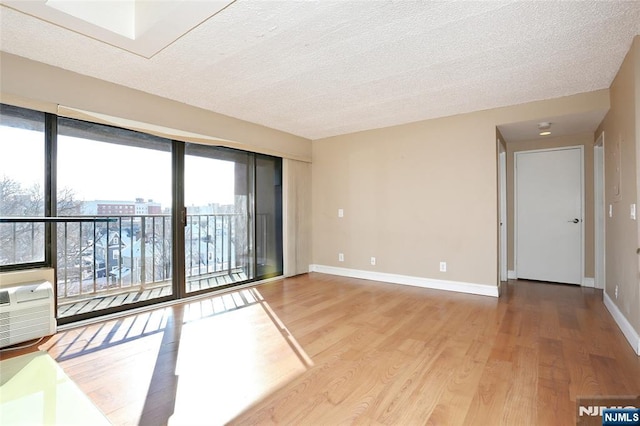 spare room with wood-type flooring and a textured ceiling