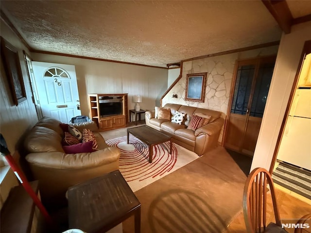 living room featuring a textured ceiling, crown molding, and beam ceiling