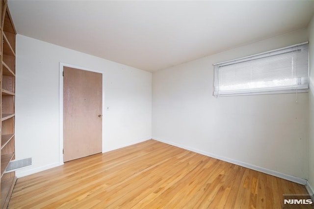 unfurnished room featuring light hardwood / wood-style floors