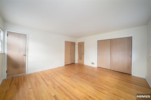 unfurnished bedroom featuring light wood-type flooring