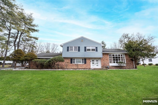 split level home with a front yard and french doors