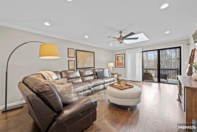 living room with ceiling fan, wood-type flooring, and crown molding