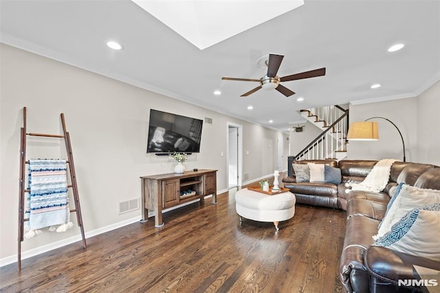 living room featuring ceiling fan, dark wood-type flooring, and crown molding