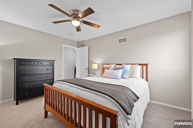 bedroom featuring light carpet and ceiling fan