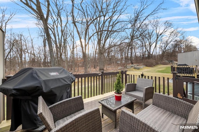 wooden deck featuring a lawn