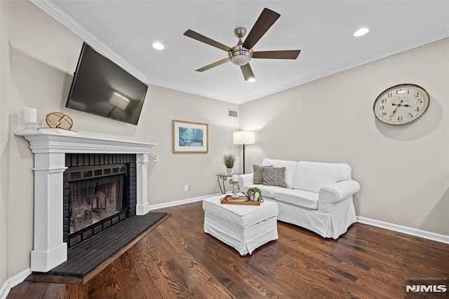 living room with ceiling fan, ornamental molding, and dark hardwood / wood-style flooring