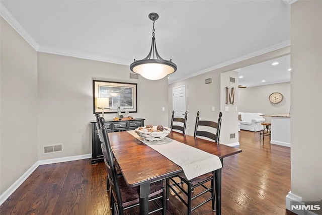 dining room featuring dark hardwood / wood-style flooring and crown molding