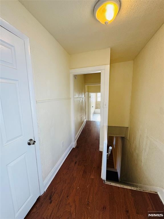 hall featuring dark wood-type flooring