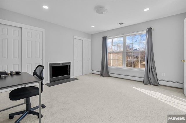 office area featuring light colored carpet and a baseboard radiator