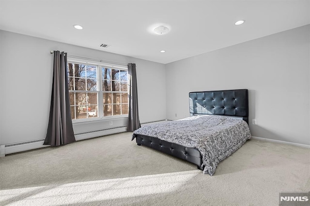 bedroom featuring carpet and a baseboard heating unit