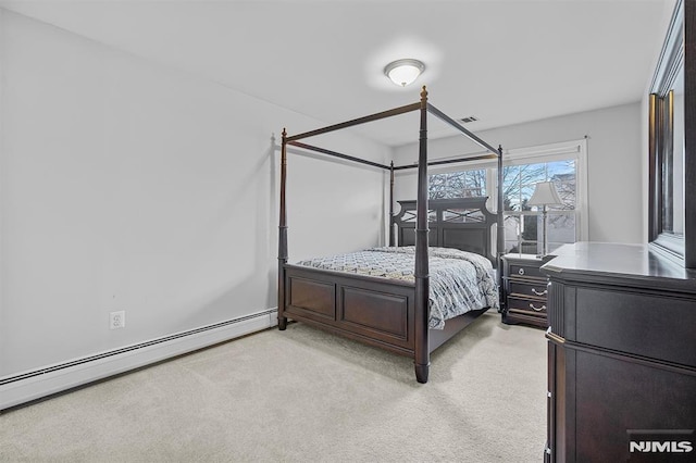 carpeted bedroom featuring baseboard heating